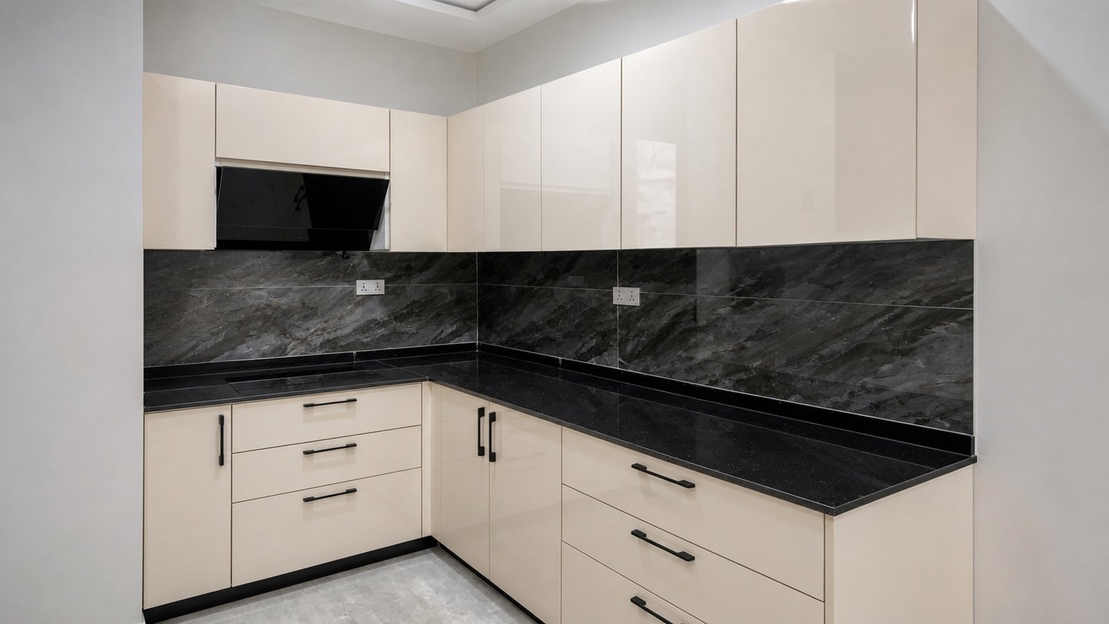 Completed DMI ivory kitchen with black worktops, matching upstand and black handles