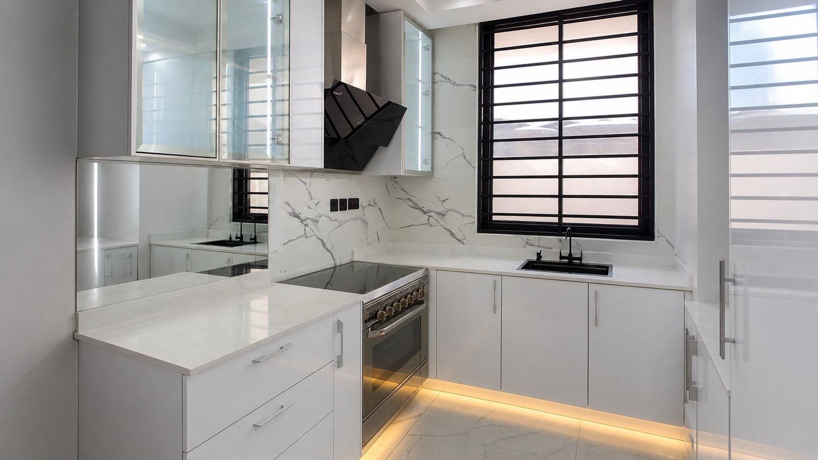 Completed DMI white kitchen with marble-veined surfaces and illuminated glass cabinetry
